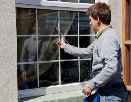 A Professional Cleaning Exterior Windows of a House